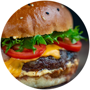 closeup view of cheeseburger with lettuce and tomato