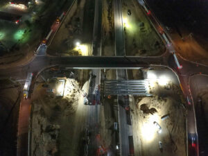 drone aerial image of interstate highway bridge demolition at night