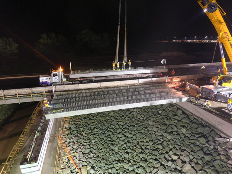 drone aerial photo of interstate bridge construction setting girders at night