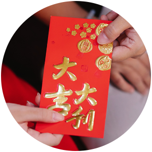 closeup of hands exchanging a chinese red packet